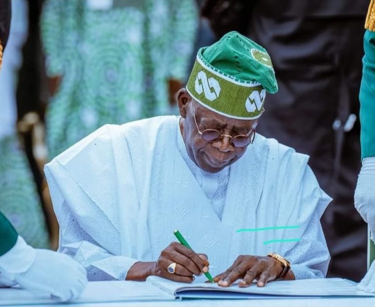 Tinubu-signs-768x630